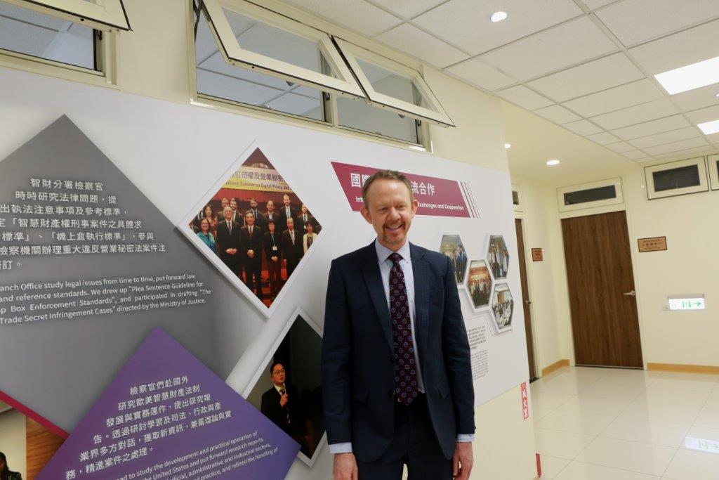 Michael Mangelson standing a photo which includes him 